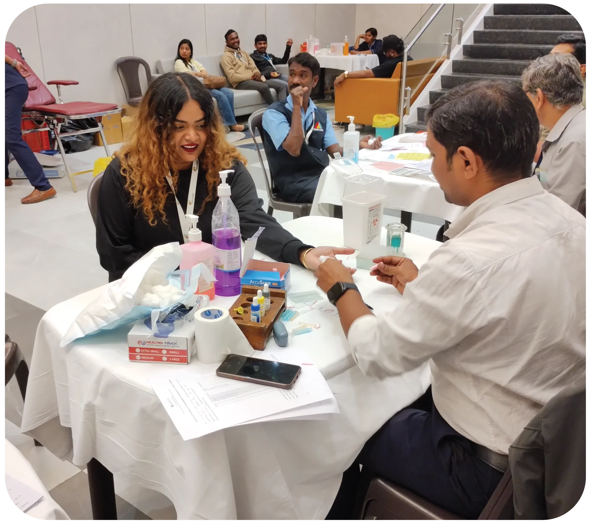 Medical professional preparing donor for blood collection procedure